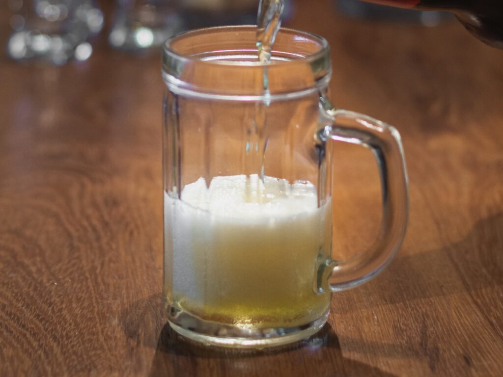 high-angle-beer-poured-from-bottle-pint